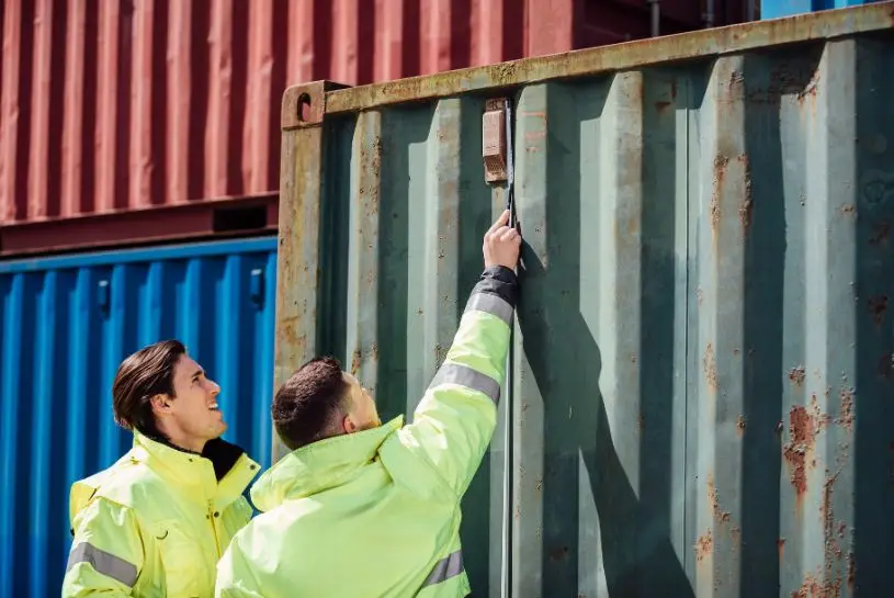 CHS team members measure a used 20ft shipping container.