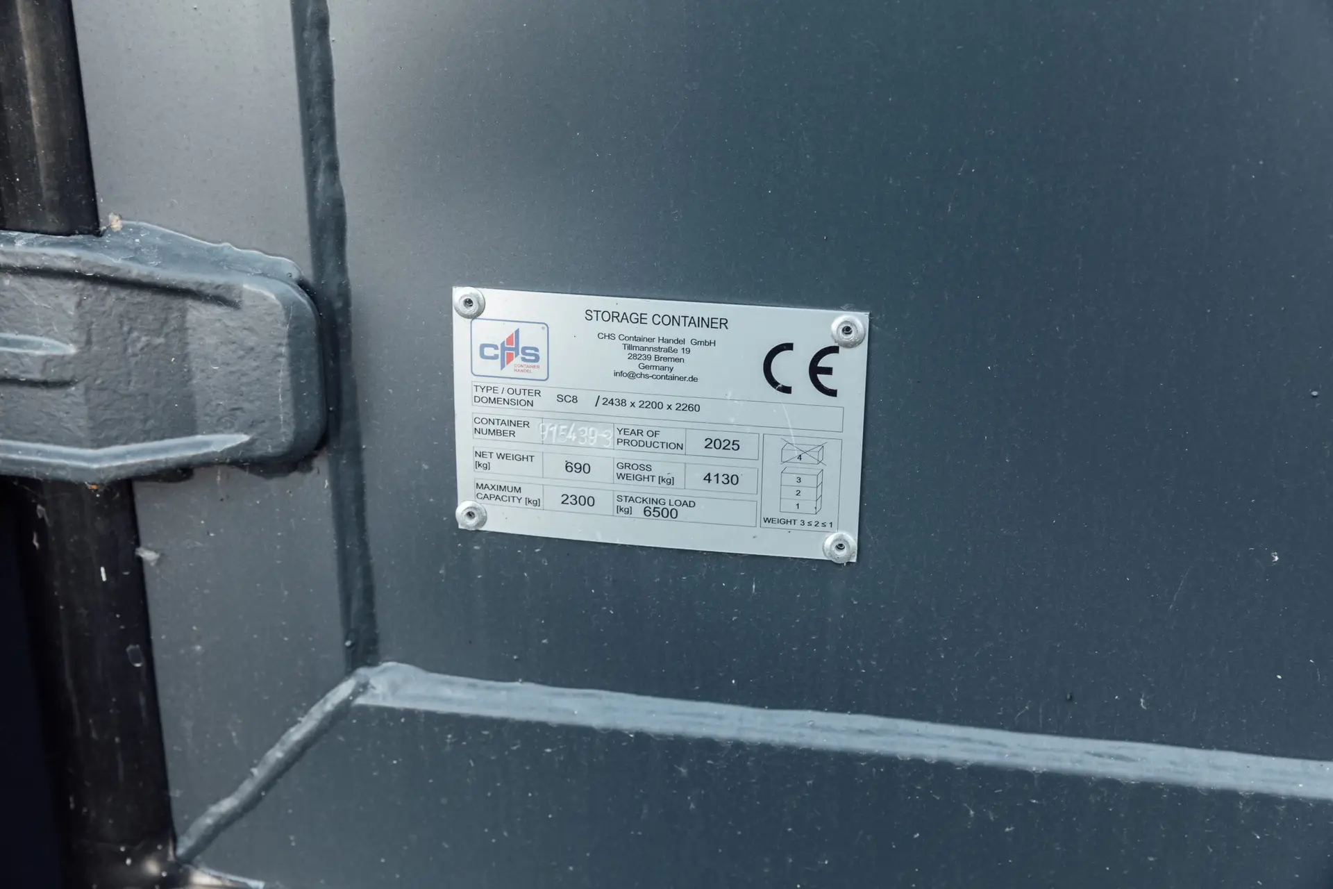 Plates on an 8-foot shipping container featuring the logo of CHS Container Group.