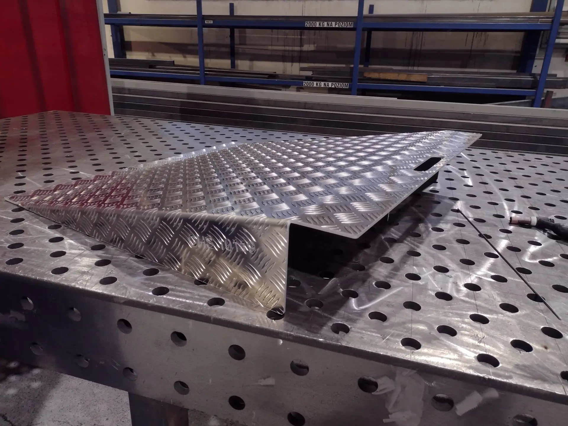 A side photo of an aluminium shipping container ramp sold by CHS Container Group.