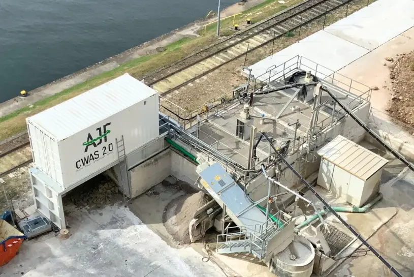 Header Anlagencontainer Anlagencontainer auf der Baustelle eines Projekte direkt an einem Gewässer. Die Ansicht ist von oben auf mehrere Container.